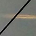 New York witness photographs hovering cigar UFO