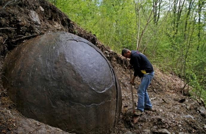 Mysterious giant sphere unearthed in forest divides opinion