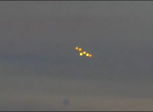 Eerie lights flying in formation in the sky raise UFO fears