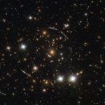 Hubble Sees Twelve Images of Same Galaxy Split by Gravitational Lens