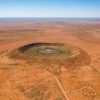 Meteorite crater discovered while drilling for gold in outback WA estimated to be 100 million years old